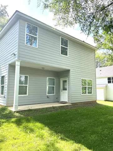a view of a house with a backyard