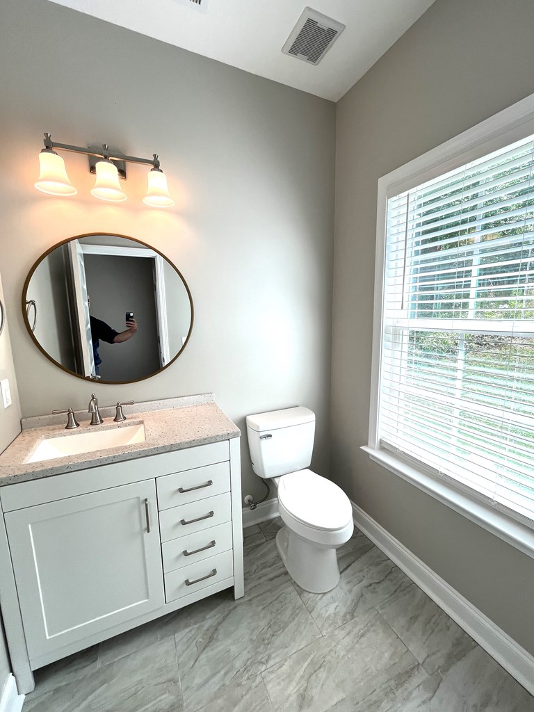 4024 Valley Road Columbus, GA 31907 - Photo 10 of 35 a bathroom with a toilet sink and mirror