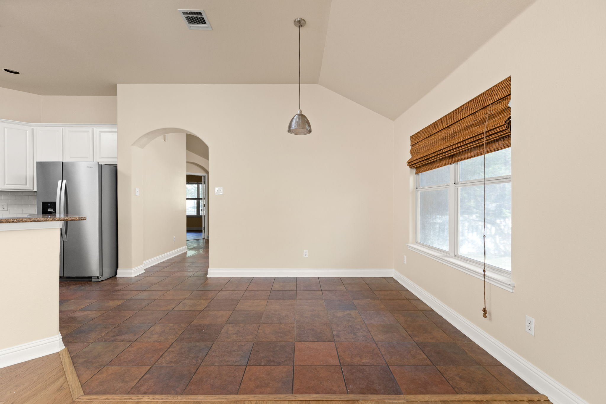 784 Sampson Kyle, TX 78640 - Photo 26 of 40 A vaulted ceiling and durable tile flooring highlight this versatile dining space near the kitchen.