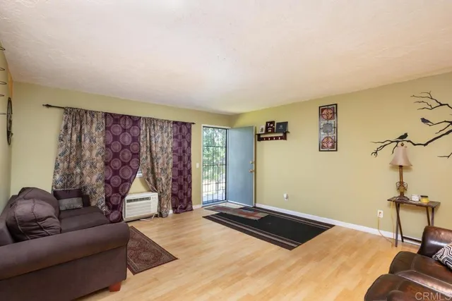 a bedroom with a bed couch and a window