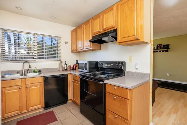 a kitchen with stainless steel appliances granite countertop a stove a sink dishwasher and a refrigerator
