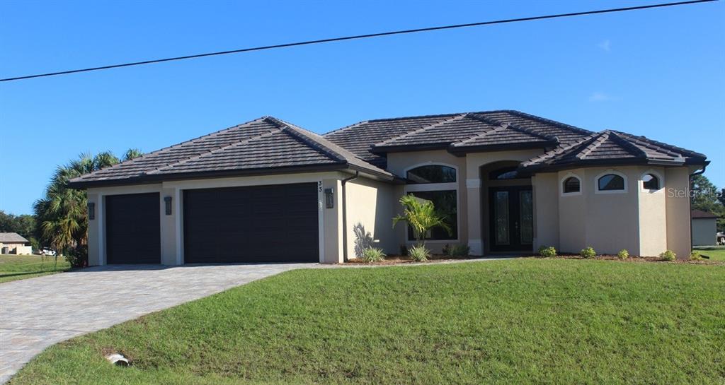 33 Tournament Road Rotonda West, FL 33947 - Photo 1 of 1 a front view of a house with a garden