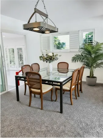 a dining room with furniture and window