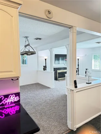 a view of kitchen and living room with a sink