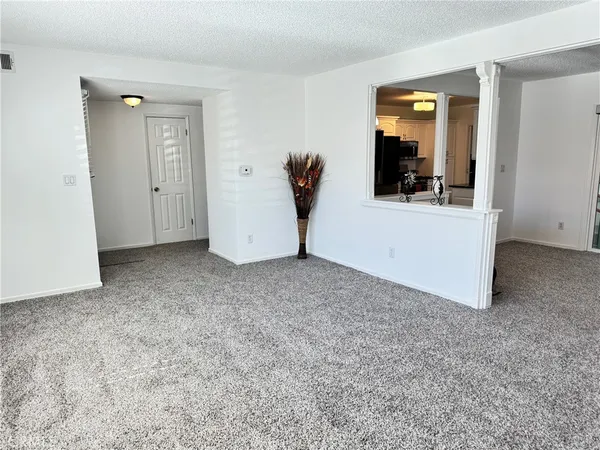 a kitchen with stainless steel appliances kitchen island granite countertop a sink and white cabinets