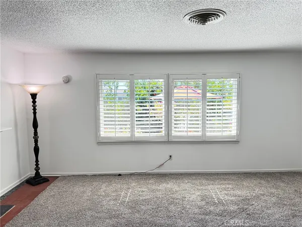 a bathroom with a granite countertop sink and a shower
