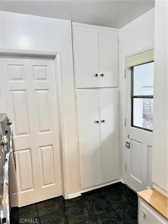a view of an empty room with window and entryway