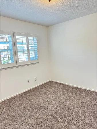 a living room with furniture and a dining table with rug