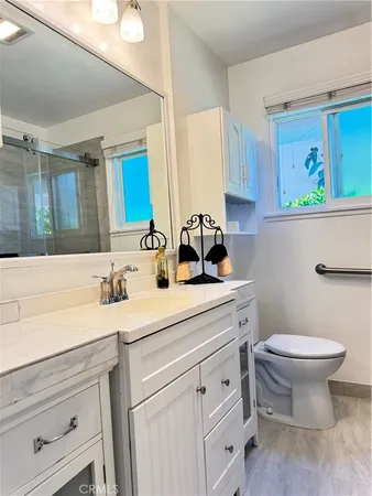 a kitchen with stainless steel appliances granite countertop a stove a sink and a wooden floors