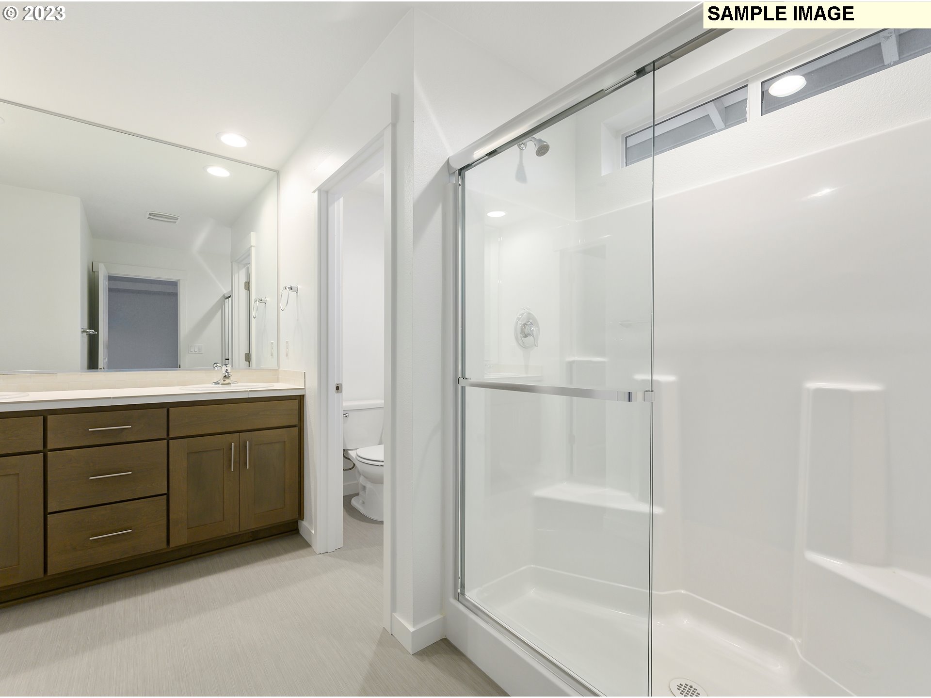 219 North 89th Loop, Unit 82 Ridgefield, WA 98642 - Photo 12 of 32 a bathroom with a shower sink vanity and mirror