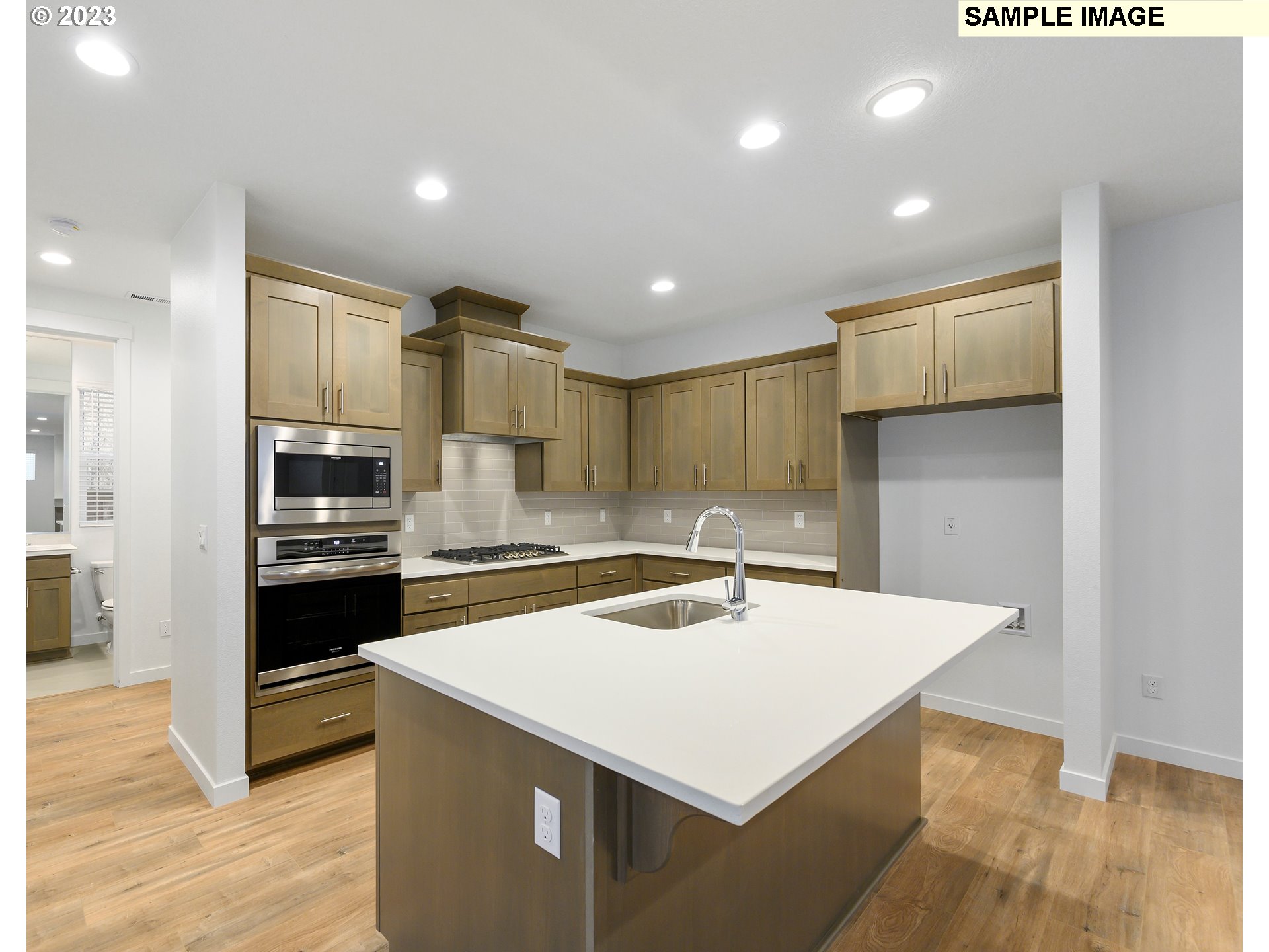 219 North 89th Loop, Unit 82 Ridgefield, WA 98642 - Photo 2 of 32 a kitchen that has a sink a stove top oven and refrigerator