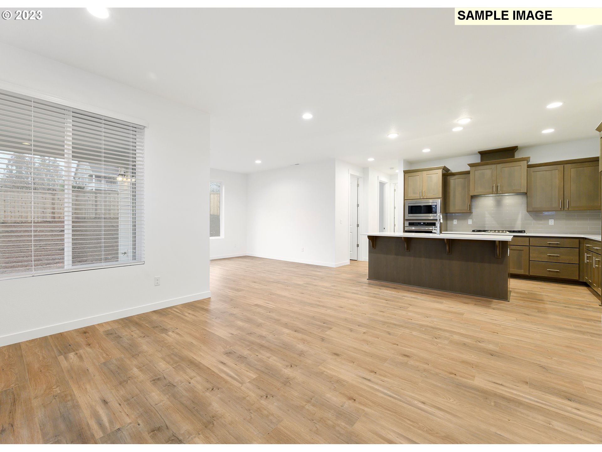 219 North 89th Loop, Unit 82 Ridgefield, WA 98642 - Photo 27 of 32 a view of kitchen with kitchen island a sink wooden floor and view living room