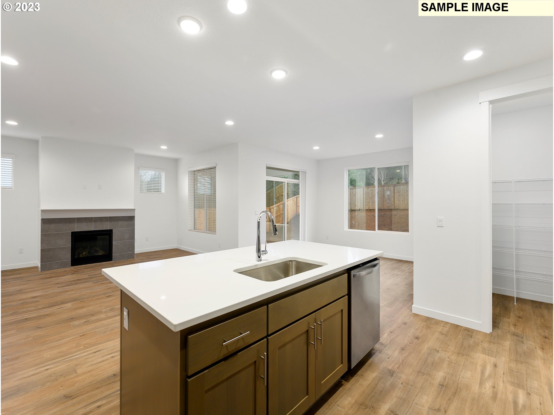 219 North 89th Loop, Unit 82 Ridgefield, WA 98642 - Photo 6 of 32 a kitchen with a sink and a fireplace