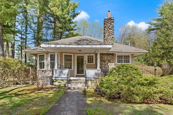 a front view of a house with a garden