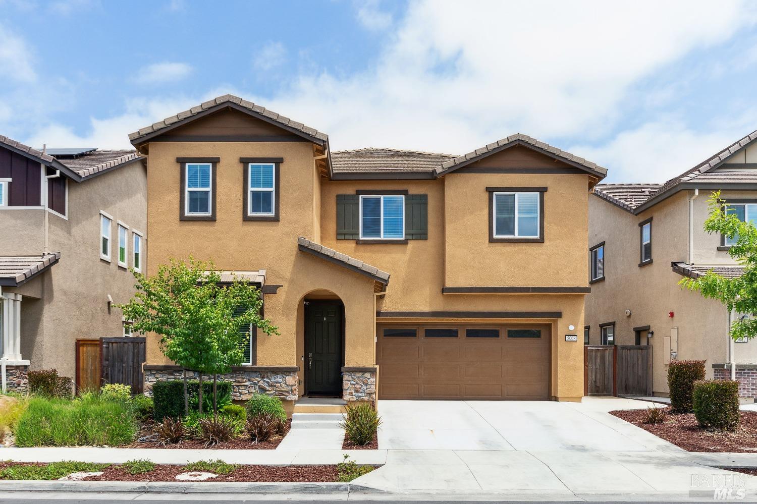 a front view of a house with yard