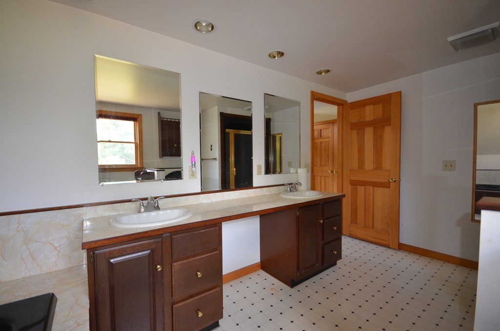 350 Warren Wright Road Belchertown, MA 01007 - Photo 17 of 30 a bathroom with a sink vanity and mirror