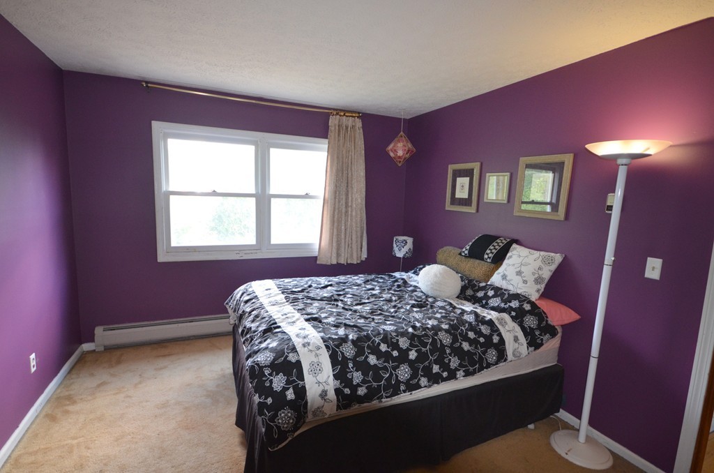 350 Warren Wright Road Belchertown, MA 01007 - Photo 19 of 30 a bed sitting in a bedroom next to a window