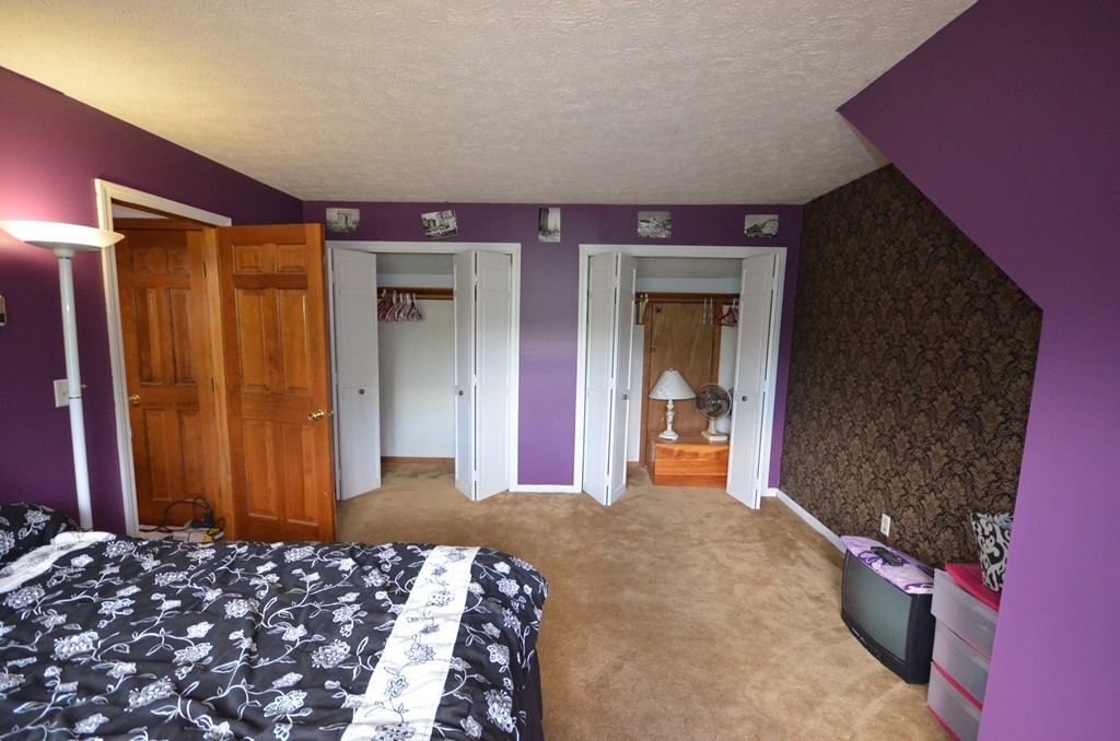 350 Warren Wright Road Belchertown, MA 01007 - Photo 20 of 30 a bedroom with a bed and a mirror