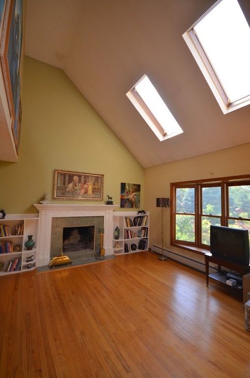 350 Warren Wright Road Belchertown, MA 01007 - Photo 5 of 30 a living room with furniture and a fireplace