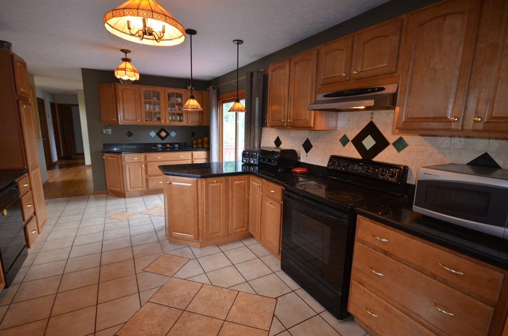 350 Warren Wright Road Belchertown, MA 01007 - Photo 9 of 30 a kitchen with a sink cabinets and stainless steel appliances