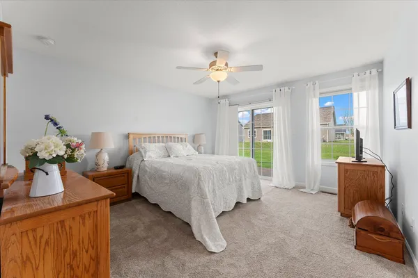a bedroom with bed and ceiling fan