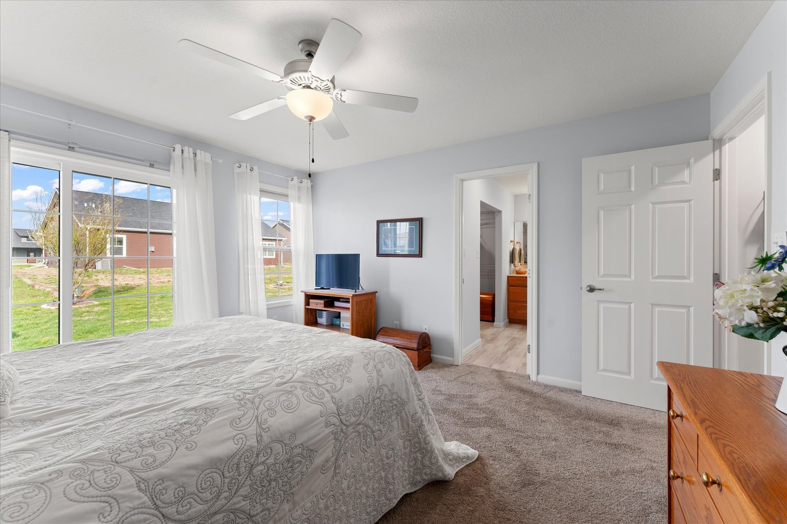 3503 South Deer Ridge Drive Urbana, IL 61802 - Photo 24 of 51 a bedroom with a bed and a chandelier