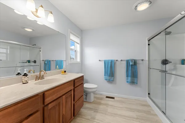 a bathroom with a double vanity sink toilet and shower
