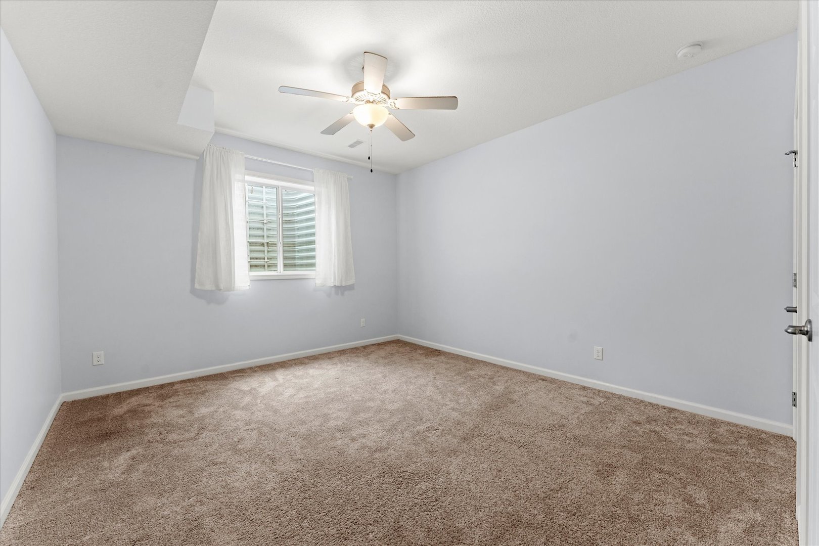 3503 South Deer Ridge Drive Urbana, IL 61802 - Photo 28 of 51 an empty room with a chandelier fan and windows