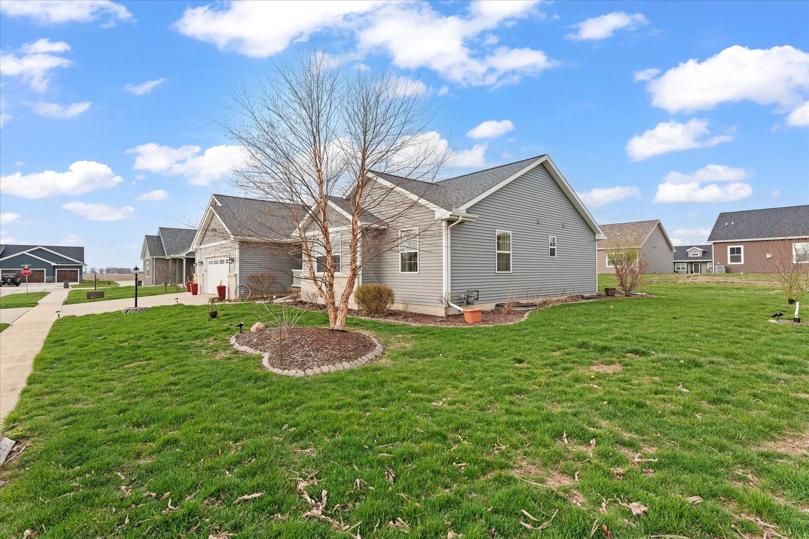 3503 South Deer Ridge Drive Urbana, IL 61802 - Photo 45 of 51 a view of a white house with a big yard and large trees