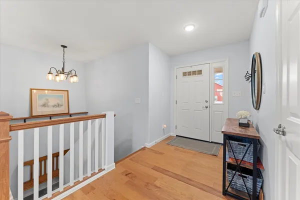 a view of a room with furniture and wooden floor