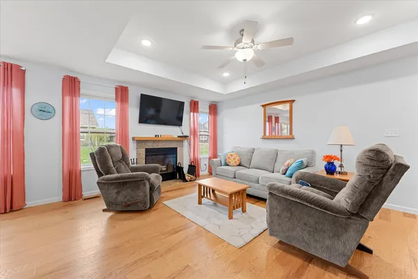a living room with furniture a fireplace and a flat screen tv