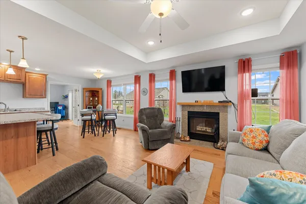 a living room with furniture a fireplace and a flat screen tv