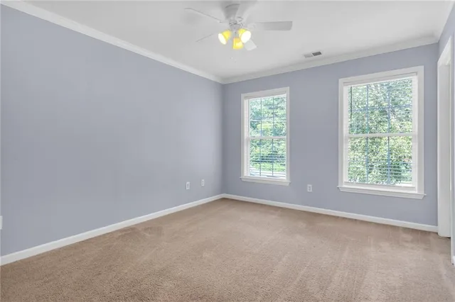 an empty room with windows and natural light