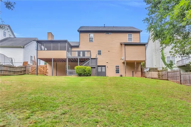 a view of a house with a yard and sitting area