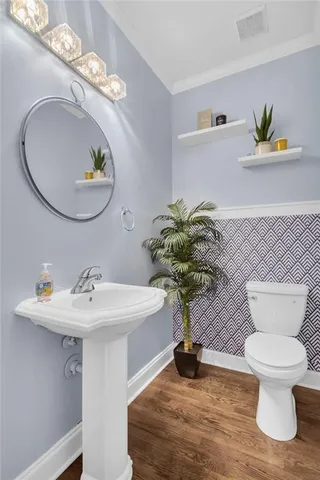 a bathroom with a sink mirror and toilet