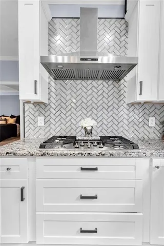 a stove top oven sitting inside of a kitchen