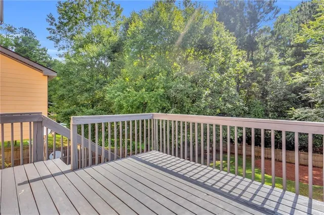 a balcony with wooden floor and fence