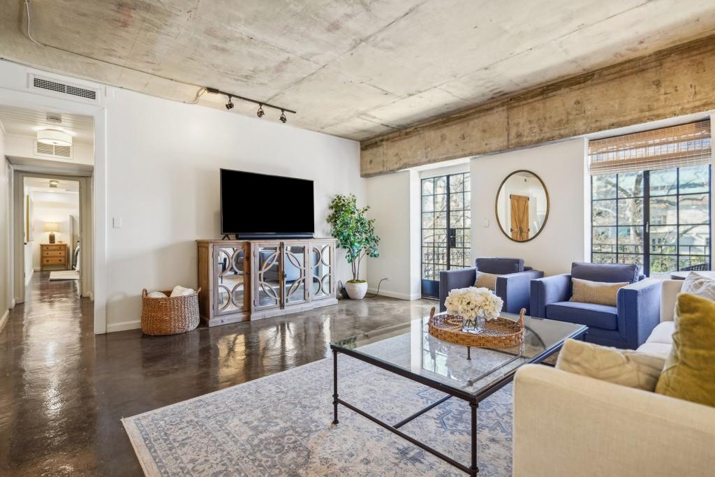 a living room with fireplace furniture and a flat screen tv