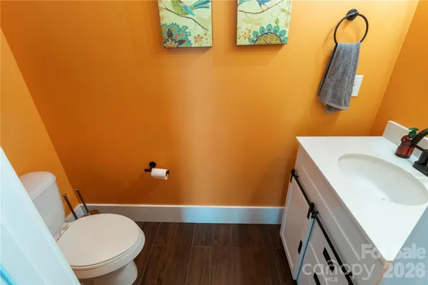 a bathroom with a sink mirror vanity and toilet