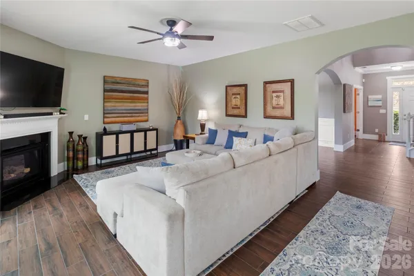 a living room with furniture fireplace and flat screen tv