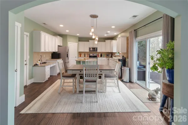 a view of a dining room with furniture and a chandelier