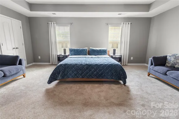 a bedroom with a bed couch and window