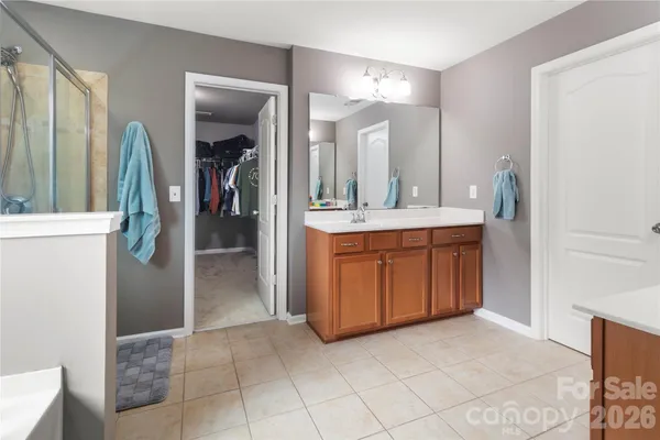 a spacious bathroom with a double vanity sink and a mirror