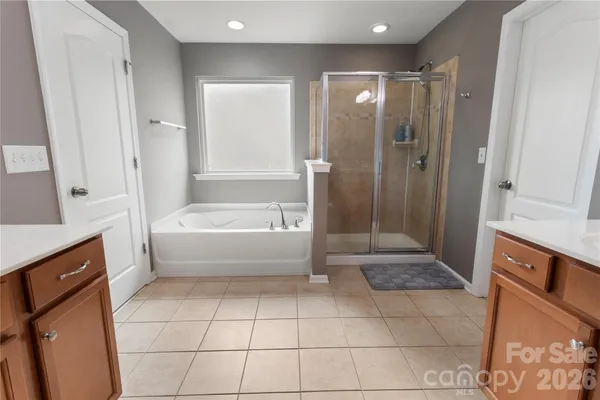 a bathroom with a tub shower and sink