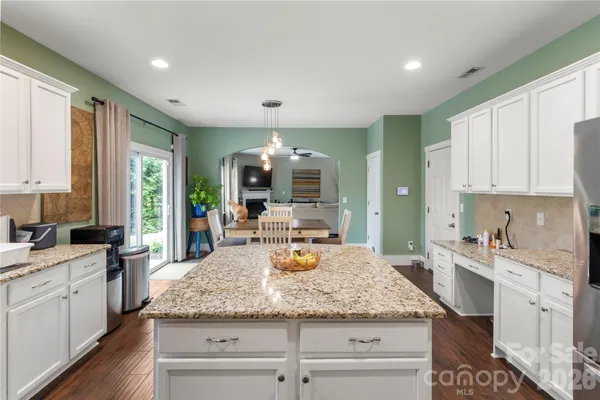 a kitchen with sink stove and cabinets