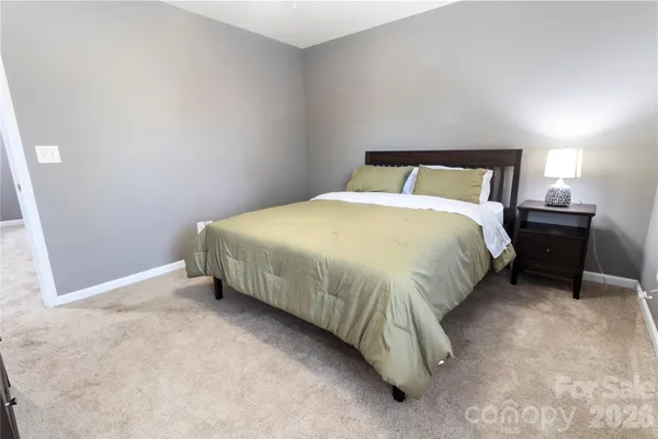 a bedroom with a bed and a night stand