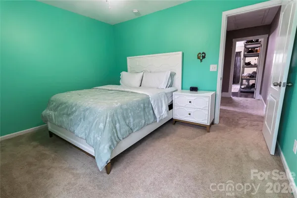 a bedroom with a bed and a table