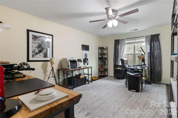 a living room with furniture a flat screen tv and a table