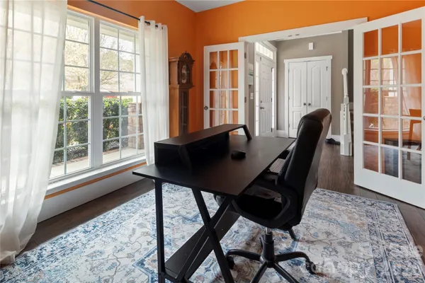 a view of a workspace with furniture and a window