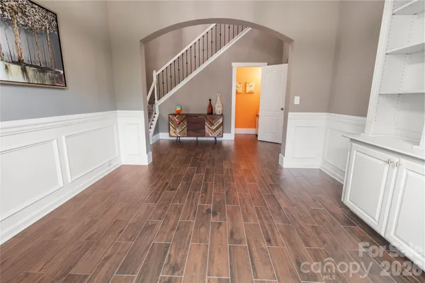a view of entryway and hall with wooden floor